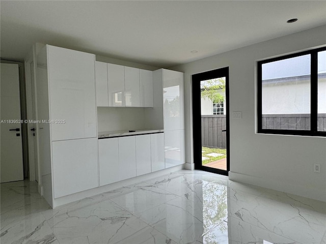 641 Nightingale Ave, Miami Springs, FL 33166 - kitchen with modern cabinets, white cabinets, light marble finish flooring, recessed lighting, and light countertops