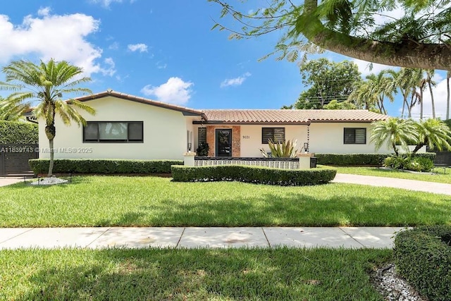 9031 SW 66th Ter, Miami, FL 33173 - view of front of house featuring a tiled roof, stucco siding, and a front yard