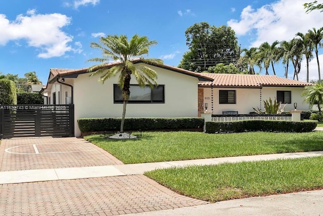 9031 SW 66th Ter, Miami, FL 33173 - mediterranean / spanish home featuring stucco siding, a tiled roof, and a gate
