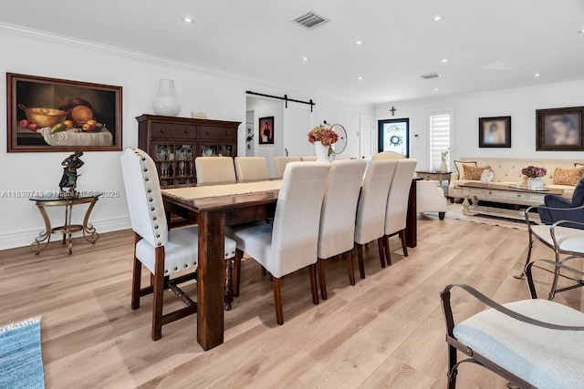 9031 SW 66th Ter, Miami, FL 33173 - dining space with a barn door, light wood-style flooring, crown molding, and recessed lighting