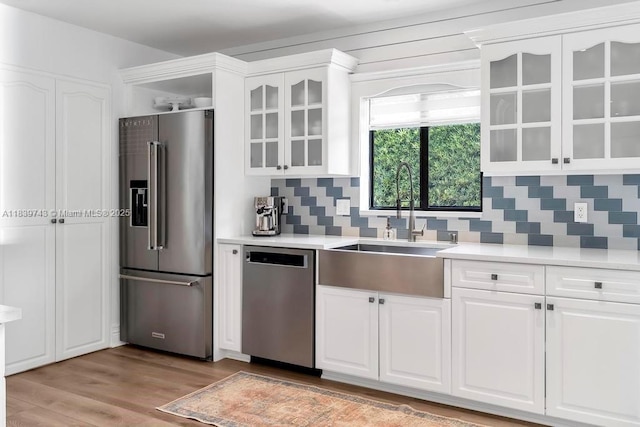 9031 SW 66th Ter, Miami, FL 33173 - kitchen with stainless steel appliances, white cabinets, backsplash, and light countertops