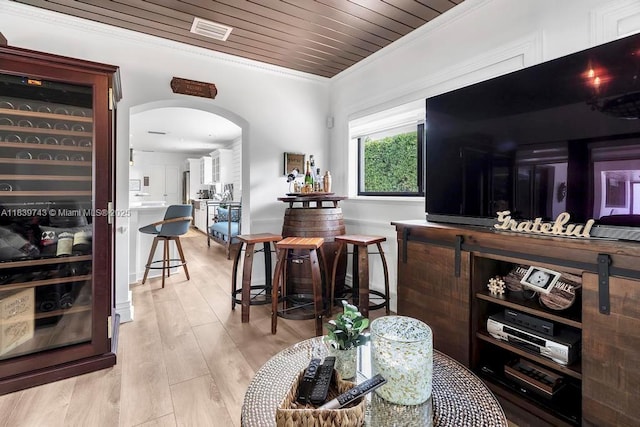 9031 SW 66th Ter, Miami, FL 33173 - living room with ornamental molding, arched walkways, light wood-style floors, and wooden ceiling