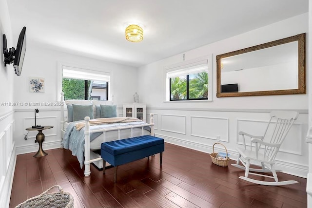 9031 SW 66th Ter, Miami, FL 33173 - bedroom with multiple windows, wainscoting, a decorative wall, and dark wood-style floors