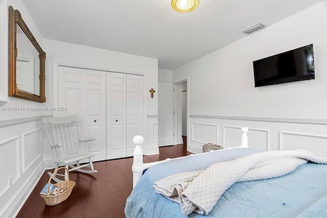 9031 SW 66th Ter, Miami, FL 33173 - bedroom with a decorative wall, wood finished floors, a closet, and wainscoting