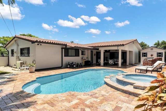 9031 SW 66th Ter, Miami, FL 33173 - back of house featuring a patio area, stucco siding, a pool with connected hot tub, and a tile roof