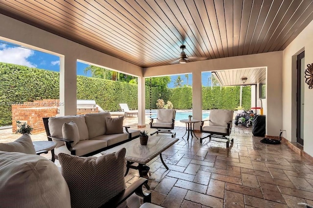 9031 SW 66th Ter, Miami, FL 33173 - fenced backyard featuring an outdoor hangout area, a patio area, and a ceiling fan
