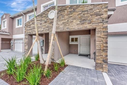 1563 NW 94th Way Unit 09, Coral Springs, FL 33071 - property entrance with stucco siding and stone siding