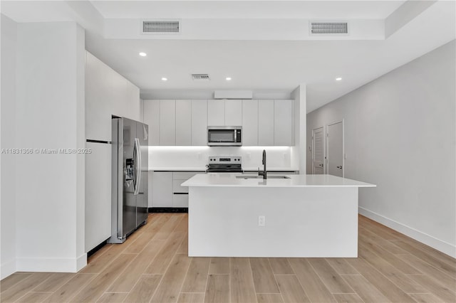 1563 NW 94th Way Unit 09, Coral Springs, FL 33071 - kitchen featuring stainless steel appliances, white cabinetry, light wood finished floors, light countertops, and modern cabinets