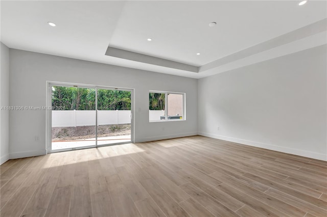 1563 NW 94th Way Unit 09, Coral Springs, FL 33071 - unfurnished room featuring plenty of natural light, light wood-style floors, recessed lighting, and a tray ceiling