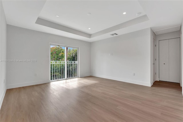 1563 NW 94th Way Unit 09, Coral Springs, FL 33071 - empty room with a tray ceiling, light wood-type flooring, a smoke detector, recessed lighting, and attic access