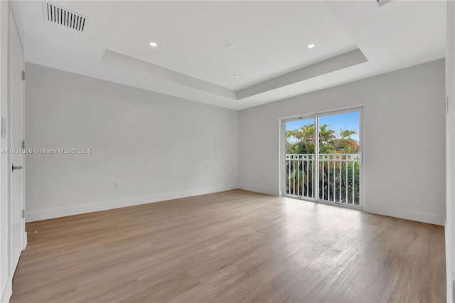1563 NW 94th Way Unit 09, Coral Springs, FL 33071 - empty room featuring a tray ceiling, light wood-style flooring, and recessed lighting