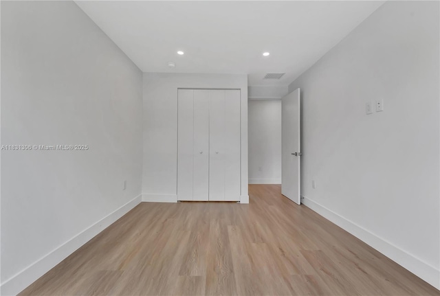 1563 NW 94th Way Unit 09, Coral Springs, FL 33071 - unfurnished bedroom with recessed lighting, light wood-style floors, and a closet