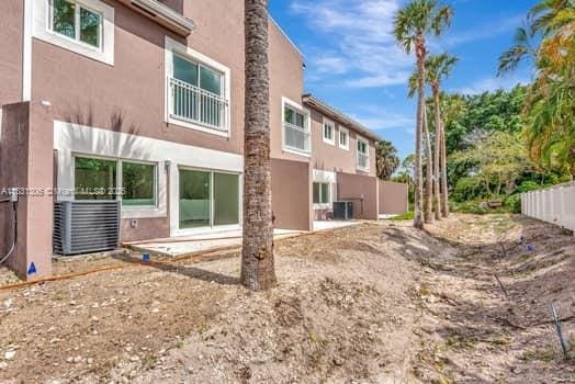 1563 NW 94th Way Unit 09, Coral Springs, FL 33071 - back of house featuring stucco siding