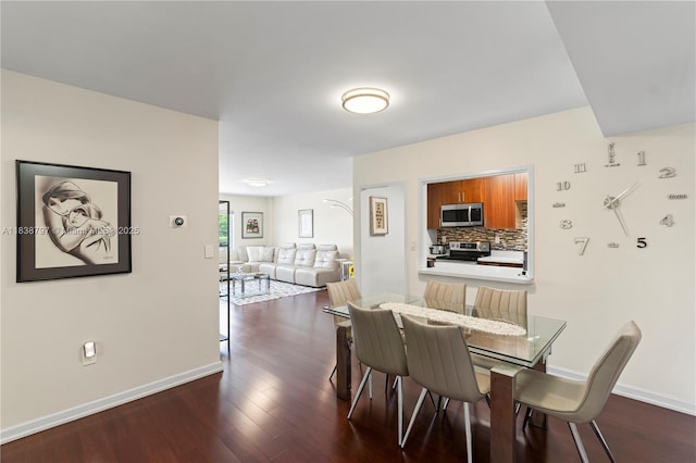 1700 NE 105th St Unit 312, Miami Shores, FL 33138 - dining space featuring dark wood-style flooring and baseboards