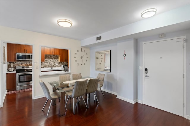 1700 NE 105th St Unit 312, Miami Shores, FL 33138 - dining space with dark wood-type flooring