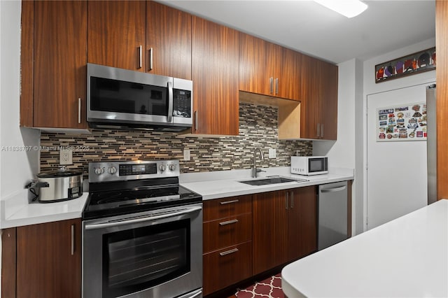 1700 NE 105th St Unit 312, Miami Shores, FL 33138 - kitchen with appliances with stainless steel finishes, light countertops, and decorative backsplash