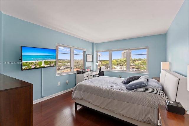 1700 NE 105th St Unit 312, Miami Shores, FL 33138 - bedroom with dark wood-style flooring and baseboards
