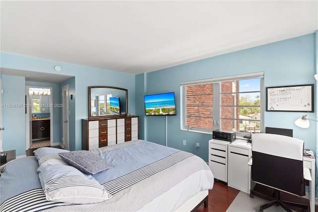 1700 NE 105th St Unit 312, Miami Shores, FL 33138 - bedroom featuring dark wood-style flooring, multiple windows, and an office area