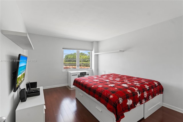 1700 NE 105th St Unit 312, Miami Shores, FL 33138 - bedroom with dark wood finished floors and baseboards
