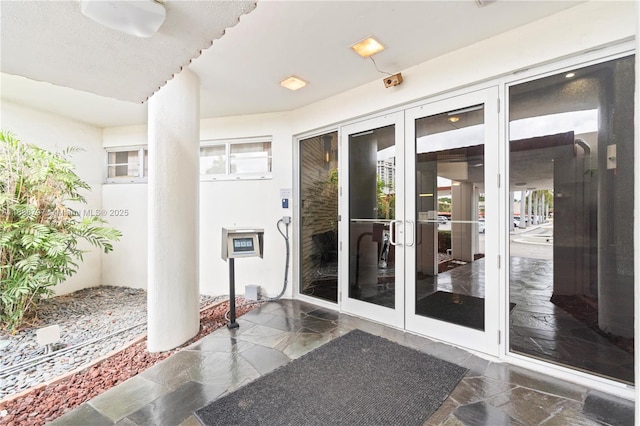 1700 NE 105th St Unit 312, Miami Shores, FL 33138 - doorway to property featuring french doors and stucco siding