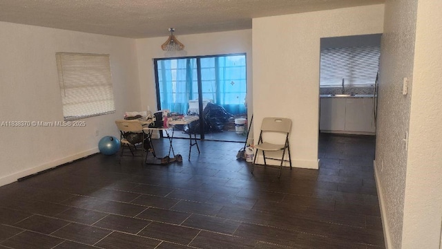 2501 NW 41st Ave Unit 201, Lauderhill, FL 33313 - dining room with a textured wall and baseboards