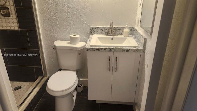2501 NW 41st Ave Unit 201, Lauderhill, FL 33313 - bathroom featuring a shower stall, vanity, a textured wall, and tile patterned flooring