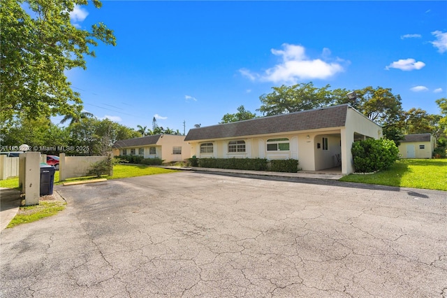 16805 SW 113th Ave Unit V41443, Miami, FL 33157 - view of front of house with a shingled roof, a front lawn, stucco siding, uncovered parking, and mansard roof