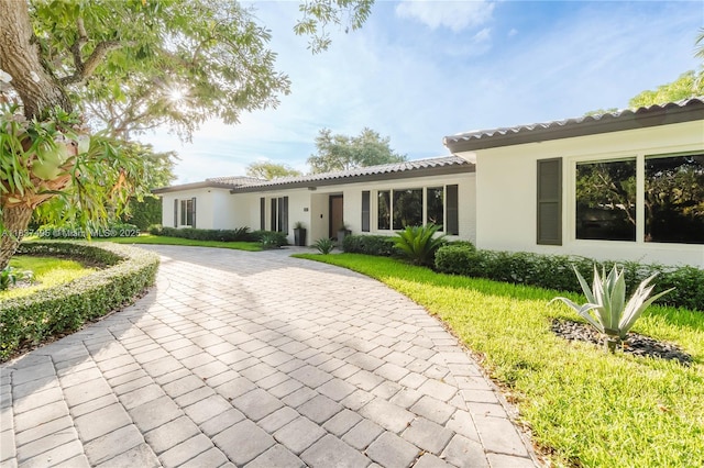 8501 SW 72nd Ter, Miami, FL 33143 - ranch-style home featuring a tile roof, stucco siding, driveway, and a front lawn
