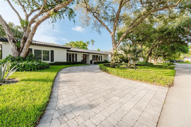 8501 SW 72nd Ter, Miami, FL 33143 - ranch-style house featuring stucco siding, a front yard, a tiled roof, and driveway