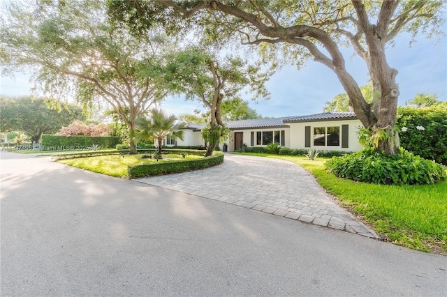 8501 SW 72nd Ter, Miami, FL 33143 - ranch-style home featuring curved driveway, stucco siding, a front yard, and a tile roof
