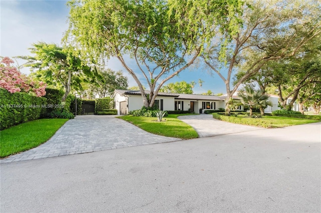 8501 SW 72nd Ter, Miami, FL 33143 - ranch-style home with decorative driveway, a front yard, stucco siding, and an attached garage