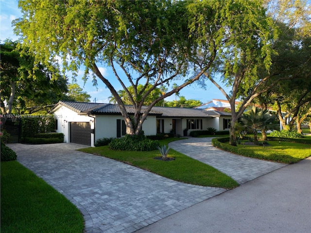 8501 SW 72nd Ter, Miami, FL 33143 - ranch-style house with decorative driveway, a garage, a front lawn, and stucco siding