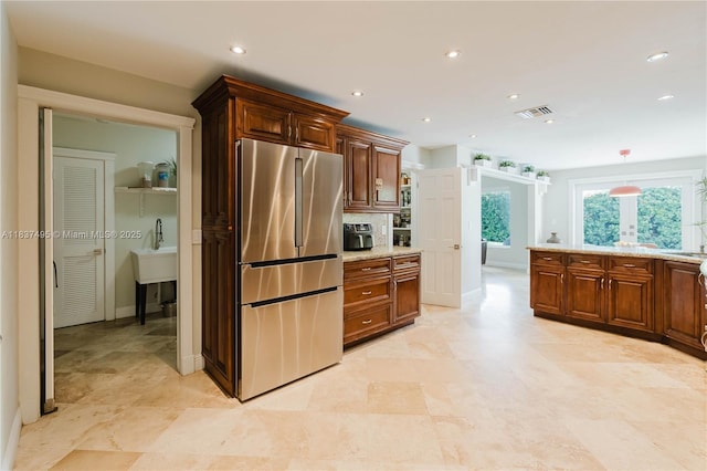 8501 SW 72nd Ter, Miami, FL 33143 - kitchen featuring freestanding refrigerator, light stone counters, recessed lighting, and backsplash