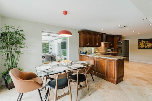 8501 SW 72nd Ter, Miami, FL 33143 - kitchen featuring wall chimney range hood, a peninsula, decorative backsplash, light stone counters, and stainless steel oven