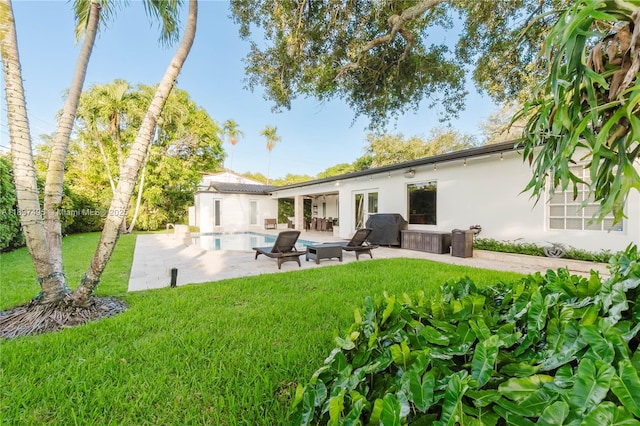 8501 SW 72nd Ter, Miami, FL 33143 - rear view of house featuring stucco siding, a yard, a patio, and an outdoor pool