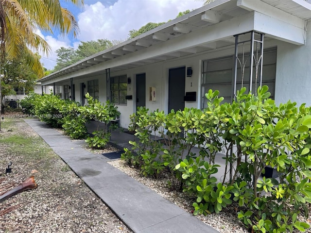 5010 NW 2nd Ave, Miami, FL 33127 - view of exterior entry with stucco siding and a porch
