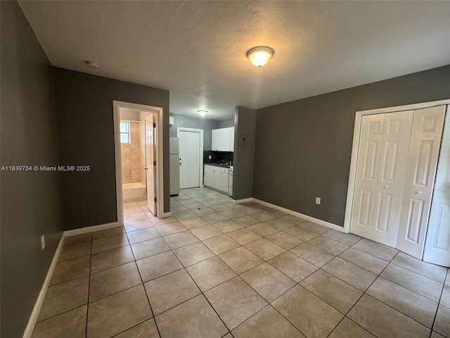 5010 NW 2nd Ave, Miami, FL 33127 - spare room featuring light tile patterned floors, a textured ceiling, and a smoke detector