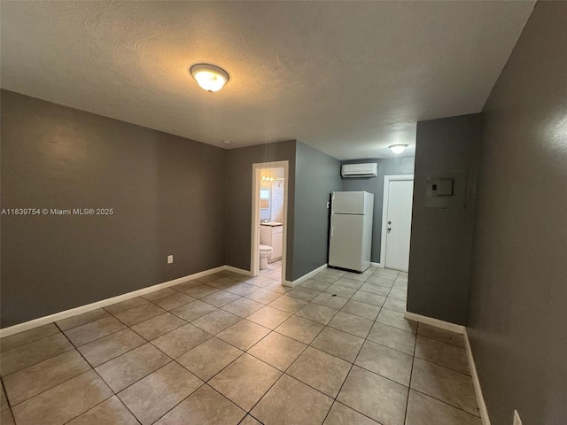 5010 NW 2nd Ave, Miami, FL 33127 - unfurnished room featuring light tile patterned floors, a textured ceiling, and an AC wall unit