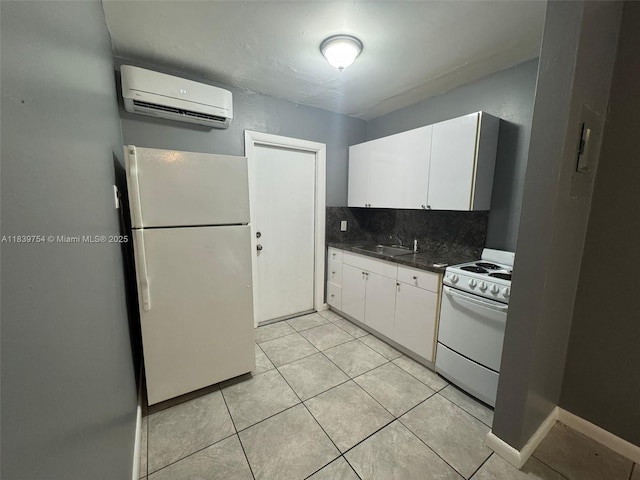 5010 NW 2nd Ave, Miami, FL 33127 - kitchen featuring white appliances, an AC wall unit, dark countertops, and white cabinetry