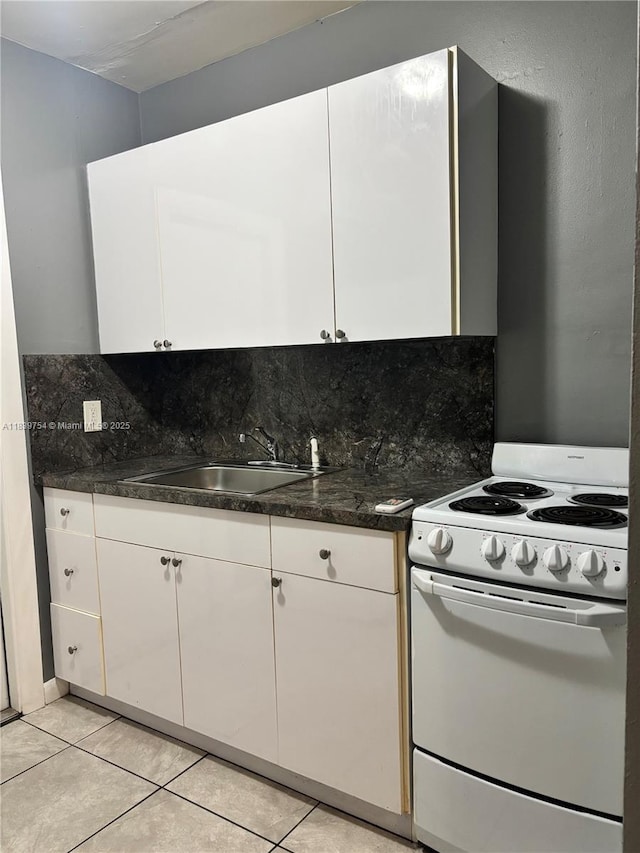 5010 NW 2nd Ave, Miami, FL 33127 - kitchen featuring white range with electric cooktop, white cabinetry, and backsplash