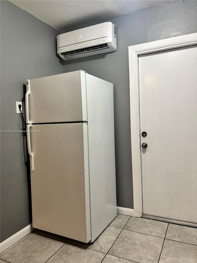 5010 NW 2nd Ave, Miami, FL 33127 - kitchen featuring freestanding refrigerator, a wall unit AC, and light tile patterned flooring
