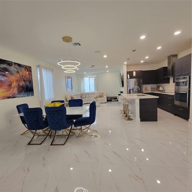 10440 NW 67th St Unit 10440, Doral, FL 33178 - dining space with recessed lighting, a chandelier, and light marble finish floors