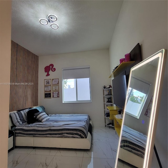 10440 NW 67th St Unit 10440, Doral, FL 33178 - bedroom with marble finish flooring, multiple windows, and a textured ceiling