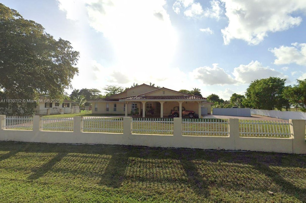 400 NW 128th Ave, Miami, FL 33182 - view of front of property with a fenced front yard, stucco siding, and a garage