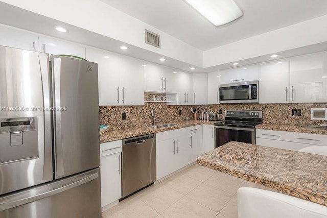 2814 N 46th Ave Unit H277, Hollywood, FL 33021 - kitchen with stainless steel appliances, white cabinets, backsplash, and light tile patterned flooring