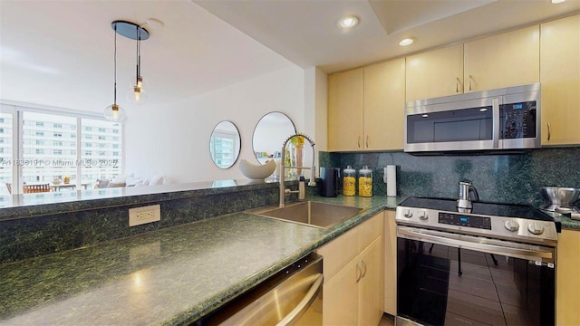 5600 Collins Ave Unit 10A, Miami Beach, FL 33140 - kitchen featuring appliances with stainless steel finishes, recessed lighting, decorative light fixtures, backsplash, and a peninsula