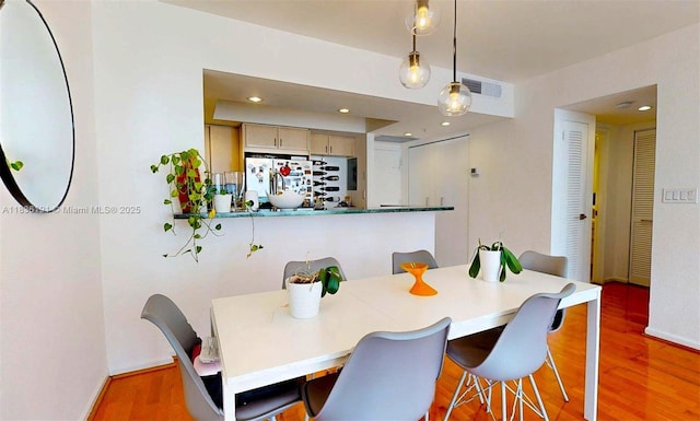 5600 Collins Ave Unit 10A, Miami Beach, FL 33140 - dining area featuring wood finished floors and bar area