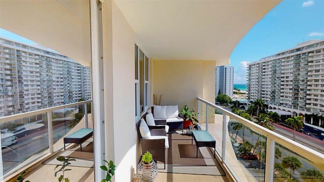 5600 Collins Ave Unit 10A, Miami Beach, FL 33140 - balcony featuring a city view, an outdoor living space, and a water view