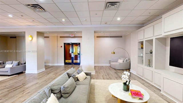 5600 Collins Ave Unit 10A, Miami Beach, FL 33140 - living room featuring light wood-type flooring, built in features, crown molding, and recessed lighting