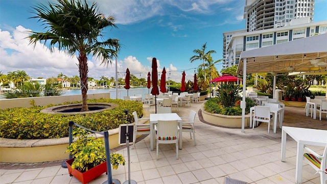 5600 Collins Ave Unit 10A, Miami Beach, FL 33140 - view of patio featuring outdoor dining area and a water view